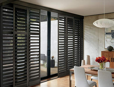 black plantation shutters installed in a room