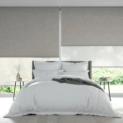 Double roller blinds inside a bedroom to limit the sunlight entering room