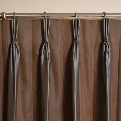 A goblet pleat curtain with brown and gray pleats