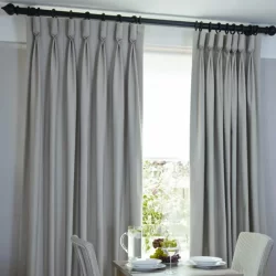 Goblet Pleat Curtains enhance the ambiance of a dining room