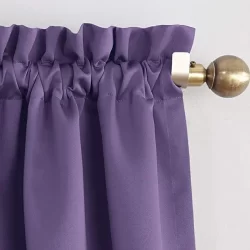 A purple ruffled curtain with a rod pocket