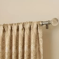 A gold and white patterned curtain with rod pocket