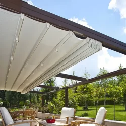 A patio with outdoor furniture and a canopy providing shade