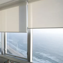 Ocean view through sunscreen blinds in a large window