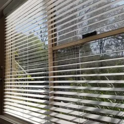 Venetian blind in the window allowing the sun light partially