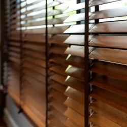 Wooden blinds in a window, providing privacy and controlling sunlight