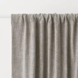 A pair of dark, heavy curtains designed to block out sunlight