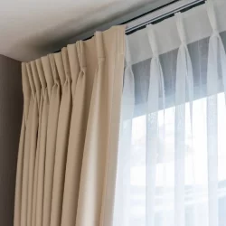 Blackout curtain hanging from window in a room
