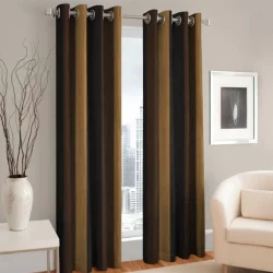 A stylish eyelet curtain in black and brown stripes, complemented by a white chair