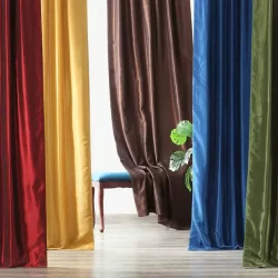 Wave fold curtains in a living room, adding elegance and style to the space