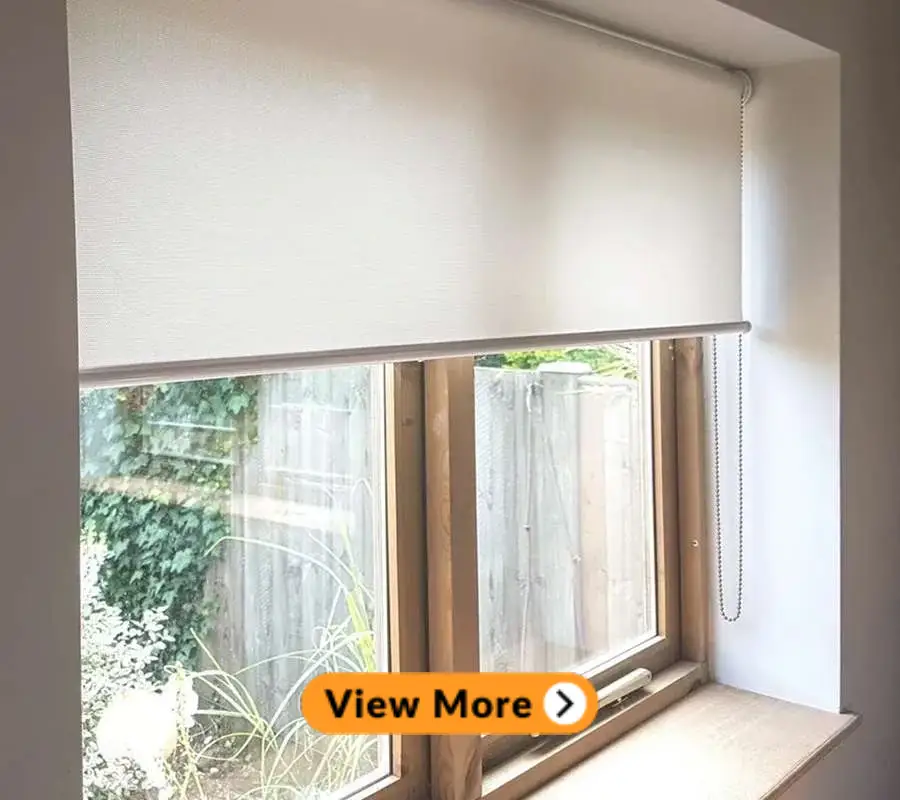 white roller blinds installed in a window