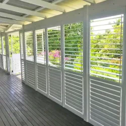 white aluminium plantation shutter installed in the front side of the home